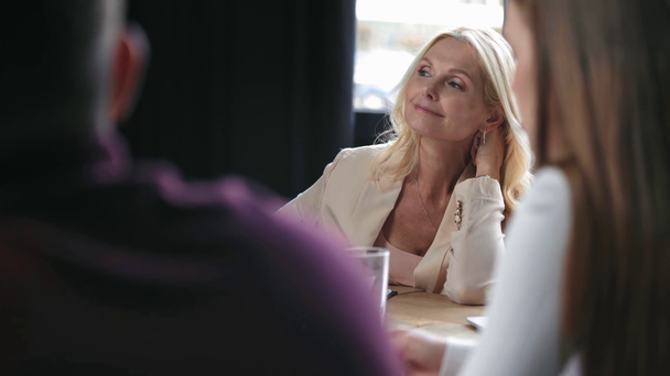smiling businesswoman listening to colleagues on business meeting - Footage, Video