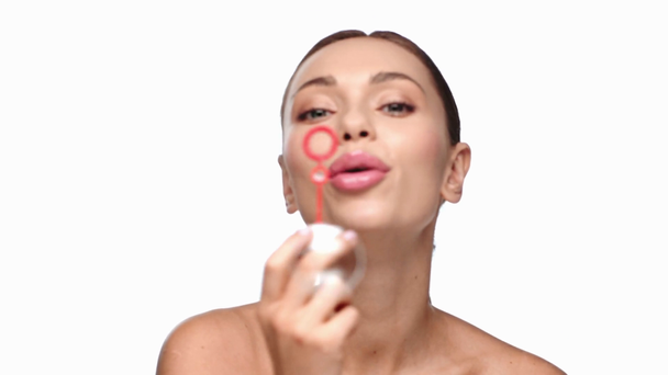 kobieta dmuchanie bańki mydlane izolowane na białym - Materiał filmowy, wideo