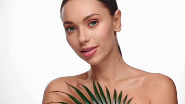 attractive woman smiling and holding leaves isolated on white - Footage, Video