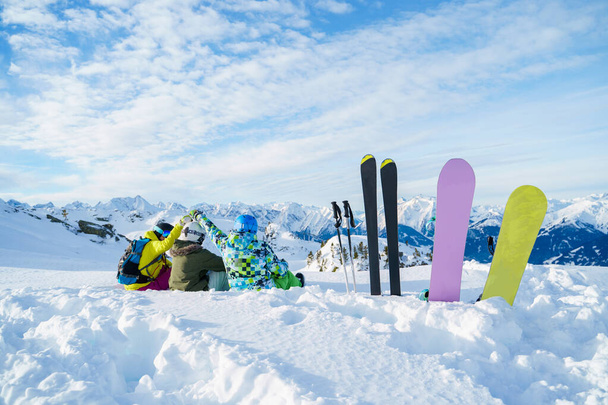 Photo from back of three athletes sitting in ski resort. - Fotografie, Obrázek