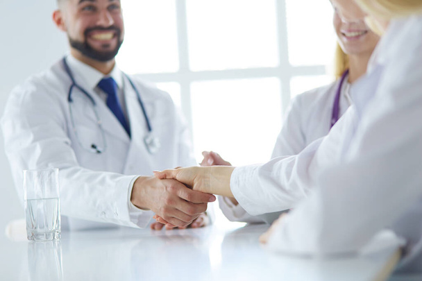 Doctor shaking hands with a male patient in the office - Foto, Imagen