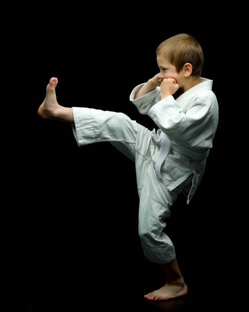 A little boy in a white kimono fulfills blows - Photo, Image
