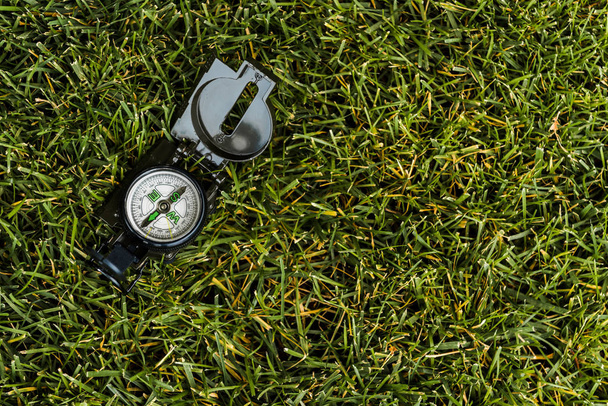 top view of retro compass on green grass  - Photo, Image