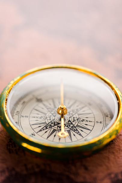 close up of vintage compass with golden arrow  - Photo, Image