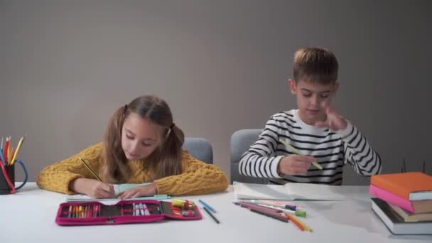 Two classmates studying at school. Tired bored boy banging head against the table. Difficulties in education process, bad behaviour. - Imágenes, Vídeo