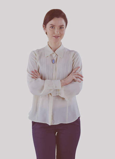 Portrait of cheerful young woman standing arms crossed over white background - Foto, afbeelding