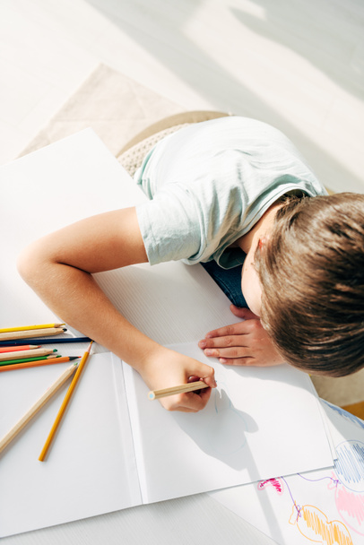 top view of kid with dyslexia drawing with pencil  - Photo, Image