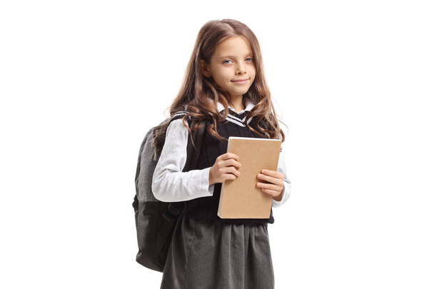 Cute schoolgirl holding a notebook - Foto, Bild
