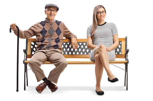 Elderly man and a young woman resting on a bench  - Photo, Image