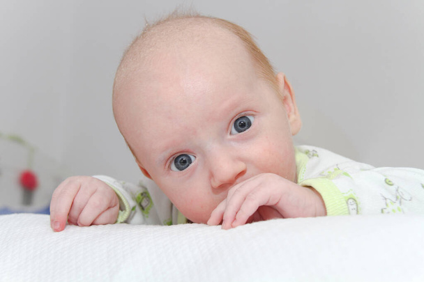 Двухмесячный новорожденный мальчик наслаждается
 - Фото, изображение