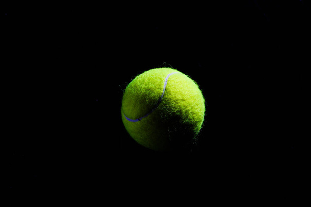 Tennis Ball isolated on black with dramatic lighting - Foto, Imagem