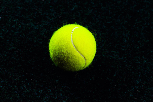 Tennis Ball isolated on black with dramatic lighting - Фото, изображение