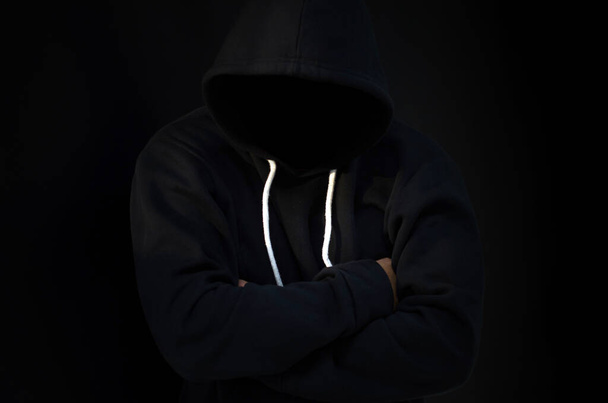 computer hacker in  hoodie. Obscured dark face. Data thief, internet fraud, darknet  - Photo, image