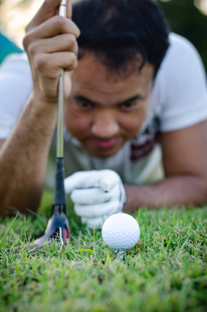 Professional golfer check line for putting golf ball on green grass - Foto, afbeelding