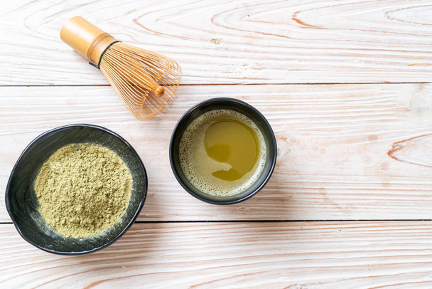 hot matcha green tea cup with green tea powder and whisk - Fotografie, Obrázek