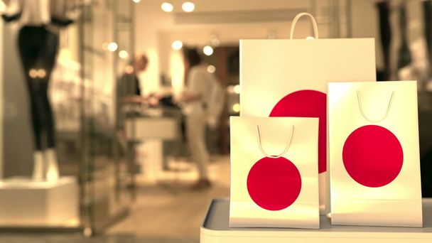 Flag of Japan on the paper shopping bags against blurred store entrance. Retail related 3D rendering - Foto, Imagem