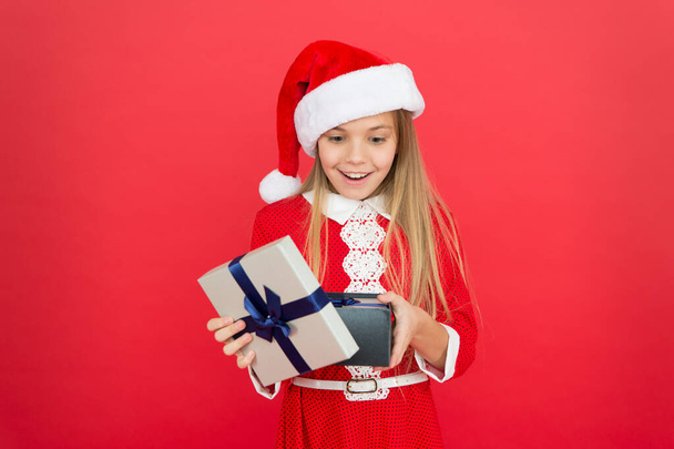 Fun time of year that you can easily tackle in a fun and organized manner. Little girl with christmas gift. Shopping concept. Winter tradition. Winter holidays. Gift from Santa. Winter season - Valokuva, kuva