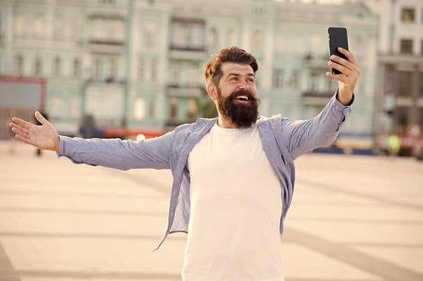 Hello world. Man taking selfie photo smartphone. Streaming online video call. Mobile internet. Tourist capture happy moment for blog. Hipster mobile phone blogger. Blog online content. Personal blog - 写真・画像
