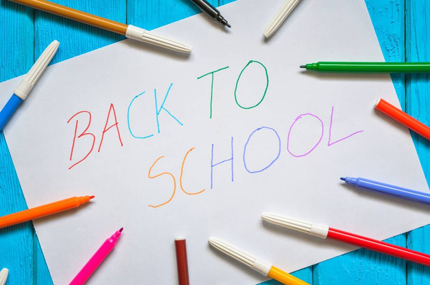 Creative idea depicting the return of children to school. School markers and a card with the text back to school. - Photo, Image