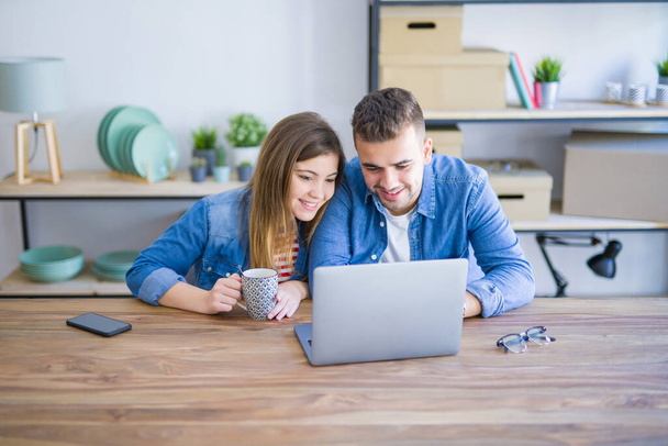 Young couple relaxing drinking a coffee and using the computer l - Photo, Image