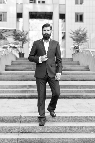 Conquer business world. Office worker confidently step on stairs. Bearded man going to work. Business man in modern city. Beginning of working day. Motivated for success. Toward business achievements - Fotoğraf, Görsel