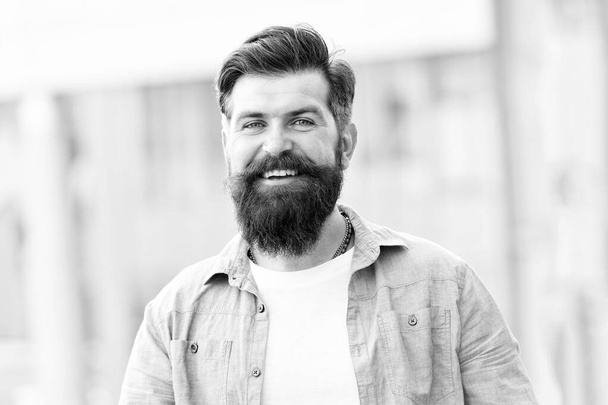 Create personal style with facial hair. Hipster with stylish beard and mustache urban background. Bearded man unshaven face hair. Barbershop and hairdresser. Masculine beauty. Styling hair tips - Foto, afbeelding