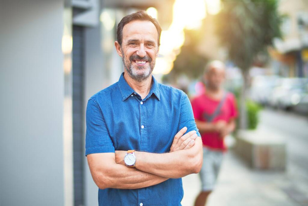 Middle age handsome man standing on the street smiling - Fotoğraf, Görsel