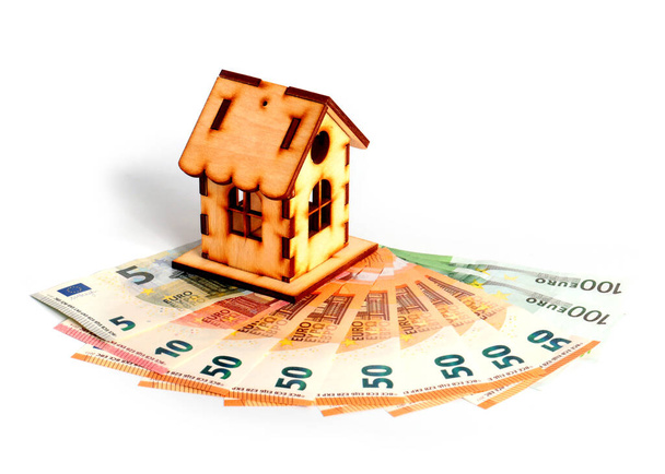 wooden house and euro paper notes as a symbol of mortgage lending - Фото, зображення