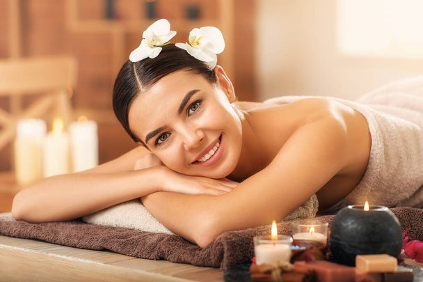 Beautiful young woman relaxing in spa salon - Photo, Image