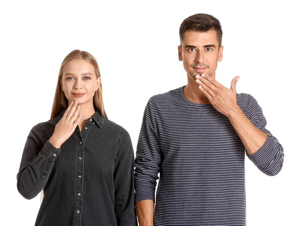 Joven pareja muda sorda usando lenguaje de señas sobre fondo blanco
 - Foto, imagen