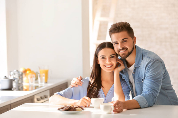 Happy young couple in kitchen at home - Photo, image