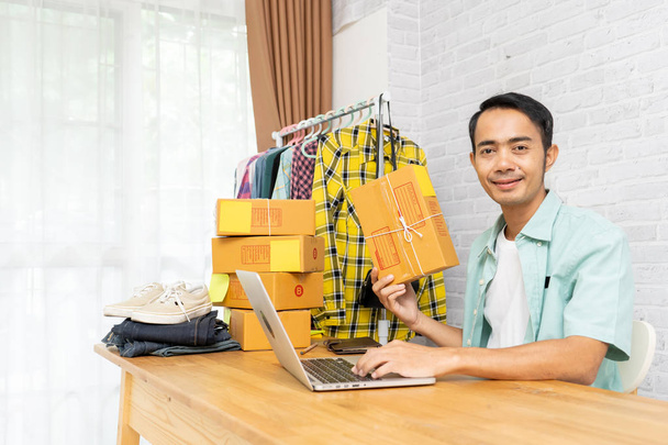 Asian man start up small business owner holding packing cardboar - 写真・画像