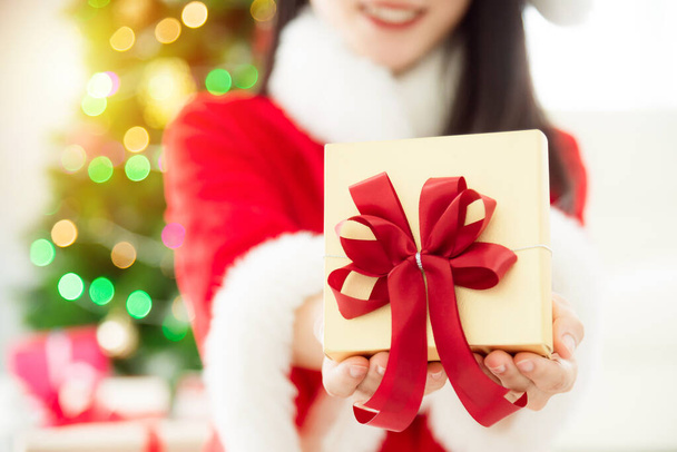 Ragazza in costume di Babbo Natale in possesso di scatola regalo, concentrarsi sulla confezione regalo
. - Foto, immagini