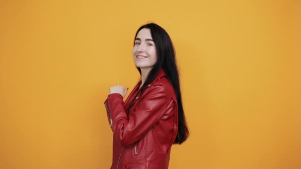 Attractive young woman in nice clothes showing thumbs up isolated on yellow wall - Filmmaterial, Video