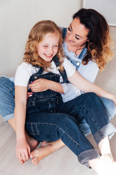 Portrait of a beautiful fashionable mom and daughters family love - Foto, Imagen