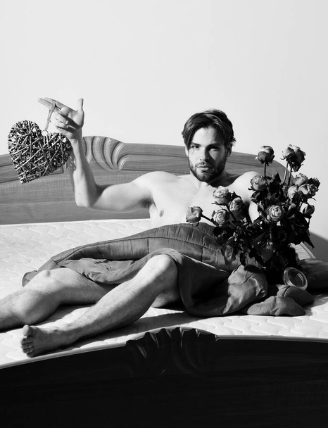 bearded macho man with roses - Фото, изображение