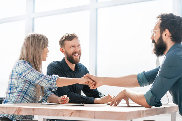 smiling business partners handshake during a business meeting. - Φωτογραφία, εικόνα