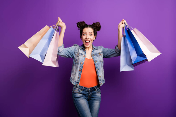 Omg look 50-off. Portrait of amazed crazy girl went shopping hold packages present what she buy on discounts wear stylish trendy outfit isolated over purple color background - Foto, immagini