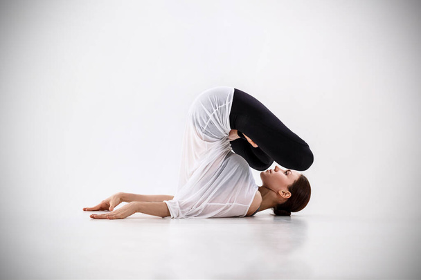 Young woman doing yoga exercise. - 写真・画像