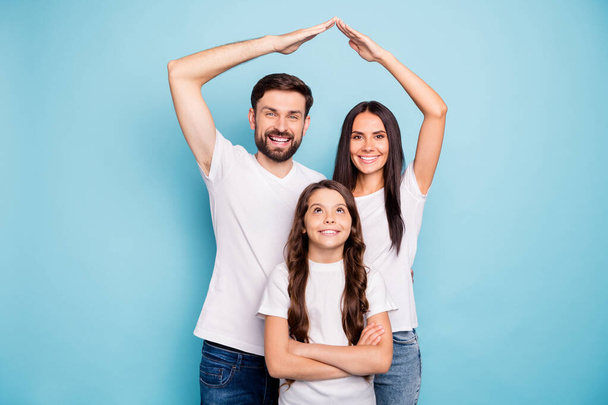 Portrait of positive lovely three people mom mommy dad daddy schoolkid have new comfort home house wear enjoy real estate wear white t-shirt isolated over blue color background - 写真・画像