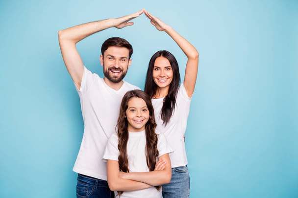 Portrait of cheerful cool three people mom dad schoolkid move new house home enjoy feel content wear white lifestyle t-shirt isolated over blue color background - Фото, изображение