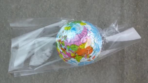 The earth in plastic bag, Global warming due to pollution by plastic debris. The concept of Earth Day.  - Video