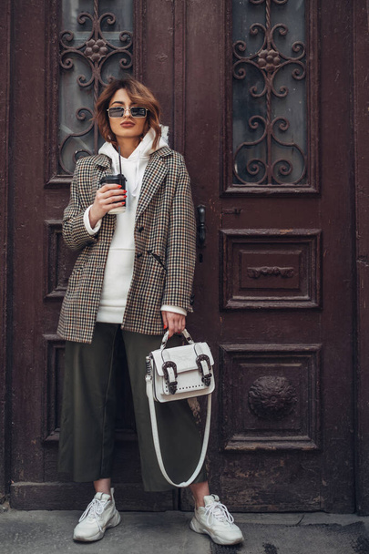 Portrait of Fashion Girl Outdoors, Wearing Stylish Jacket - Fotó, kép