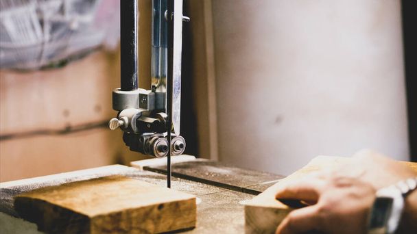 Closeup hands of male carpenter working on milling machine with wood detail - Φωτογραφία, εικόνα