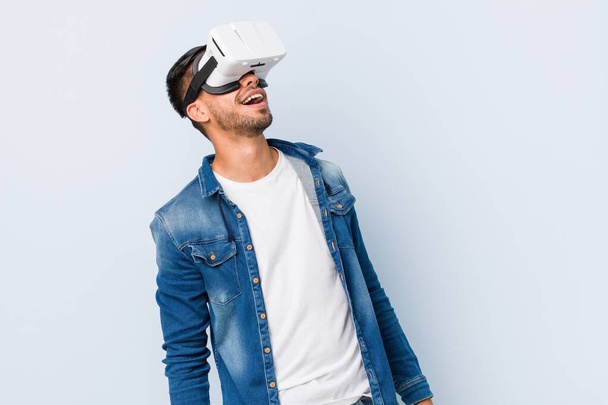 Young south-asian man playing with virtual reality glasses - Fotoğraf, Görsel