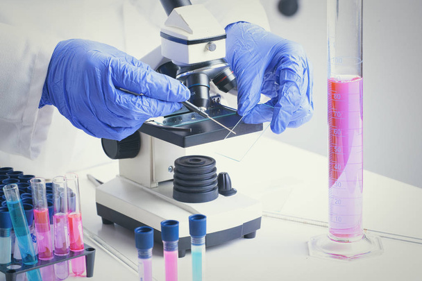 Scientist with a test tube working at the laboratory - Φωτογραφία, εικόνα