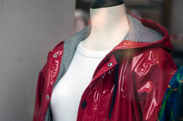 Closeup of red rain coat on mannequin in fashion store showroom - Foto, imagen