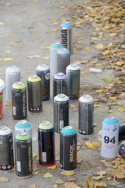 KHARKOV, UKRAINE - OCTOBER 19, 2019: Montana mtn 94 black hardcore dope and kobra used spray cans for graffiti painting outdoors in autumn leafs - Foto, Bild