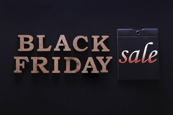 black friday themed concept with objects on black paper textured background. - Photo, Image