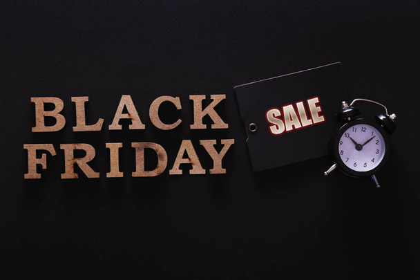 black friday themed concept with objects on black paper textured background. - Фото, изображение